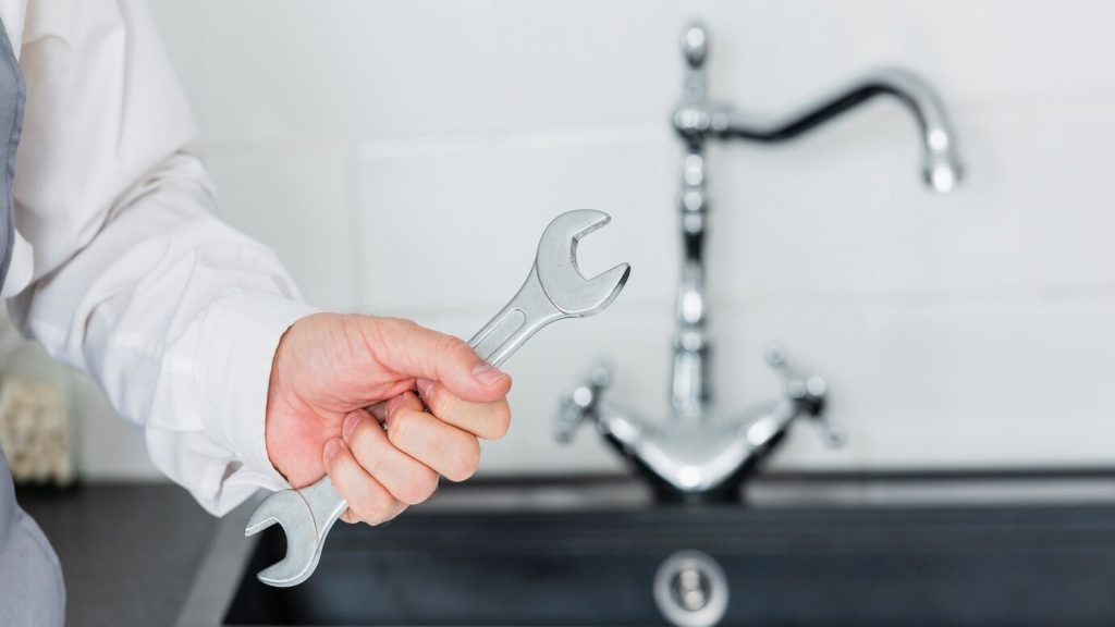 A man holding a wrench | RossCo Service Plumbers in Tacoma